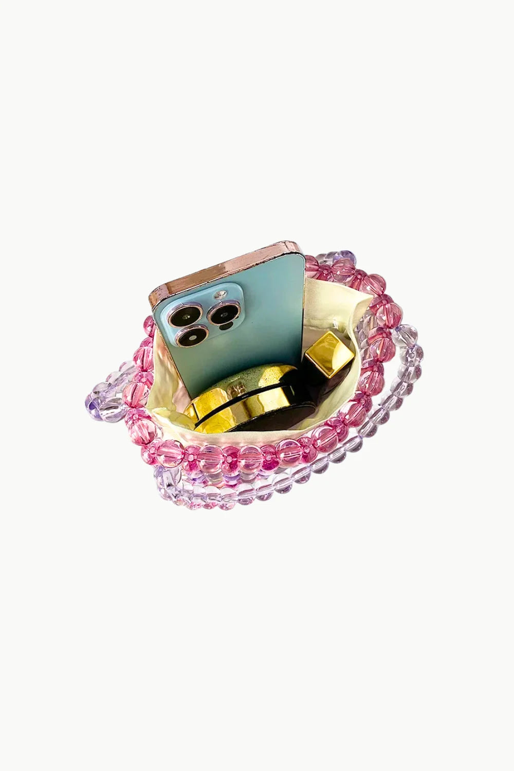 Pink and purple beaded bucket bag with smartphone and perfume inside