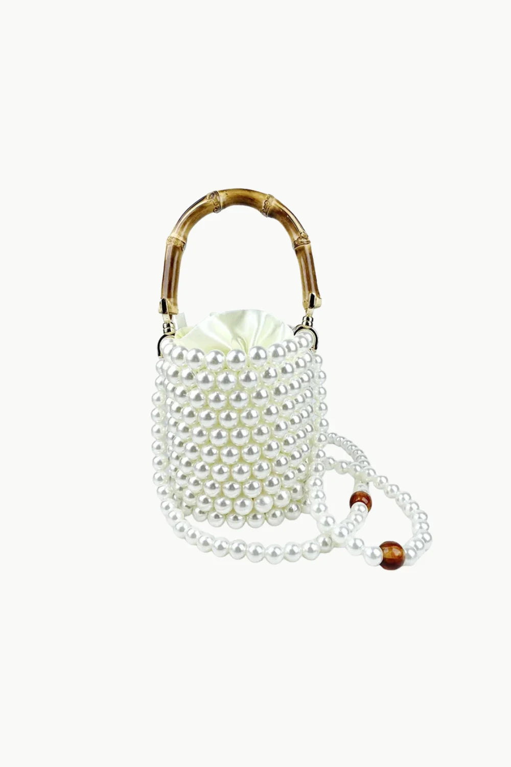 White pearl-beaded bucket bag with bamboo top handle and pearl strap for stylish looks