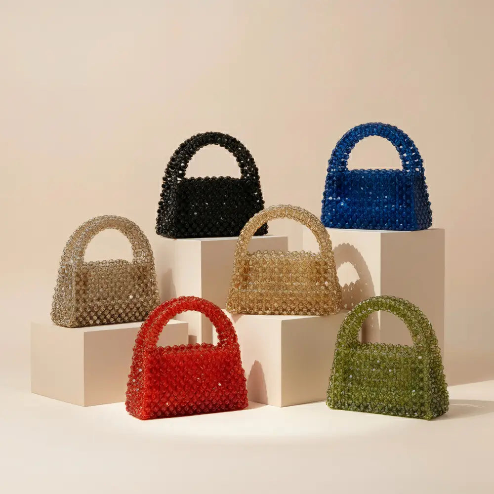 Set of colorful beaded handbags on a neutral background