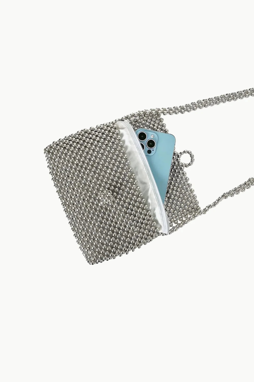 Silver beaded clutch handbag with light blue smartphone inside for elegant style