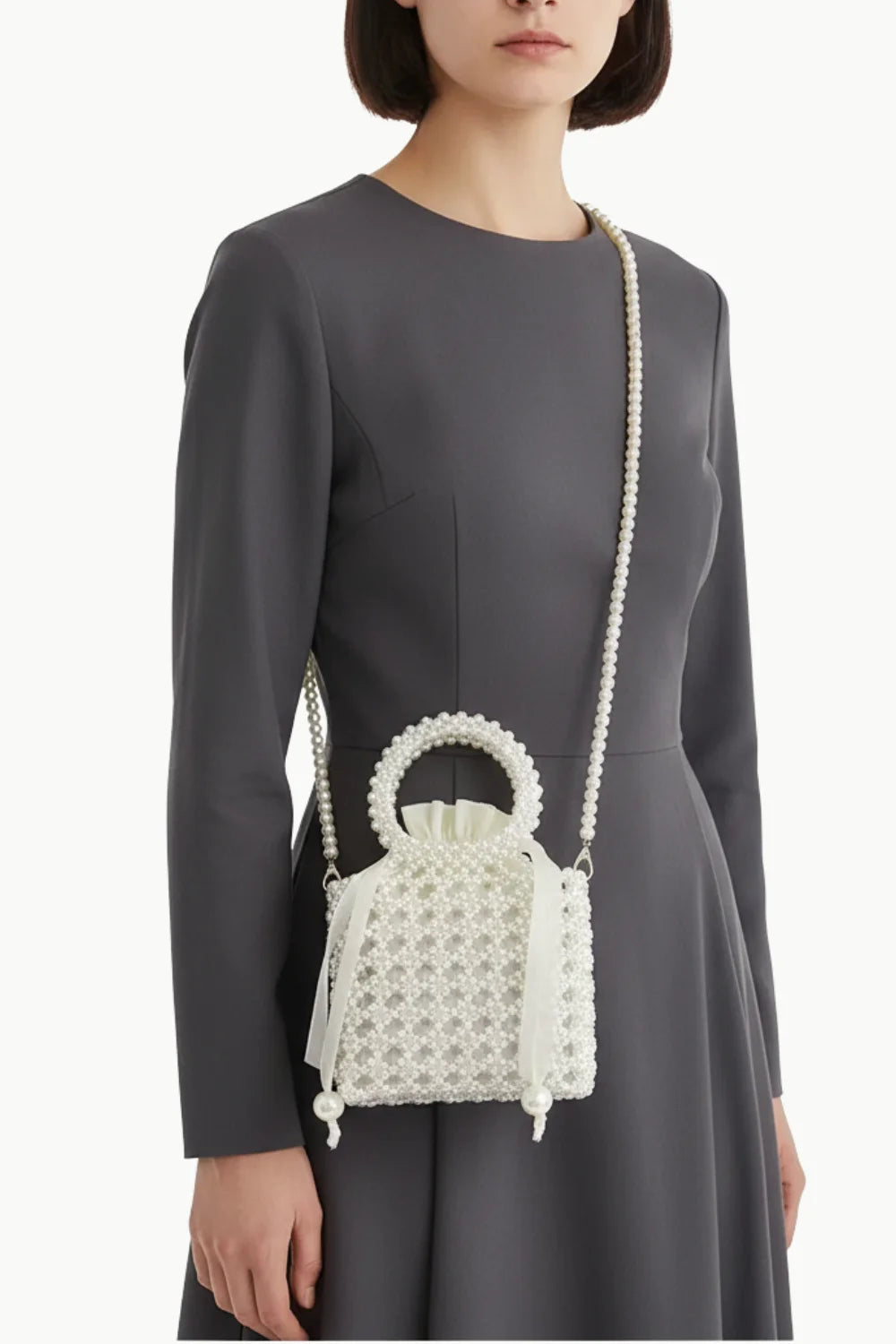 White beaded pearl handbag with top handle and shoulder strap, stylish hand beaded bag