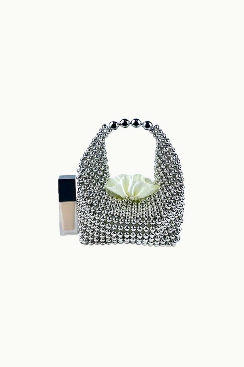 Silver metallic beaded bag with ruched cream fabric lining for elegant style
