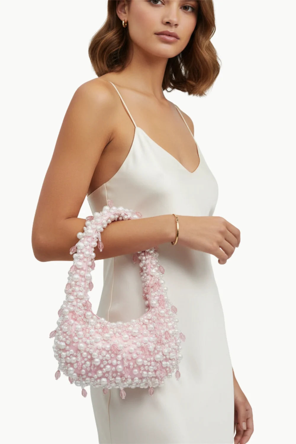 Pink and white beaded shoulder bag with curved shape and pearl bag charm handle