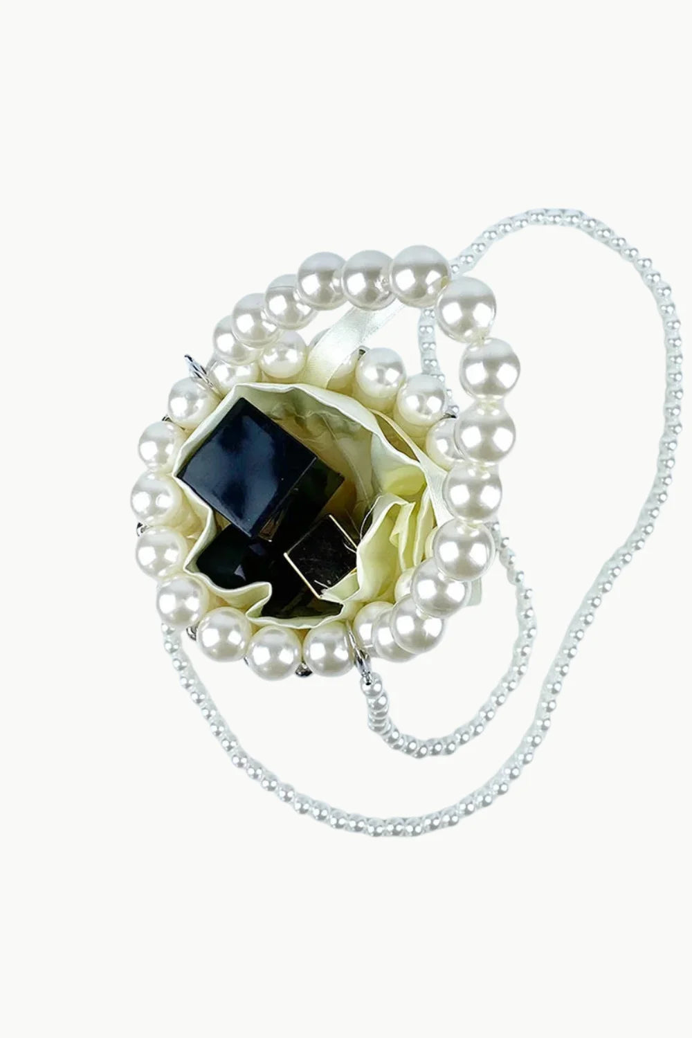Pearl Bead Bucket Bag with pearl beads, light fabric lining, and dark items inside