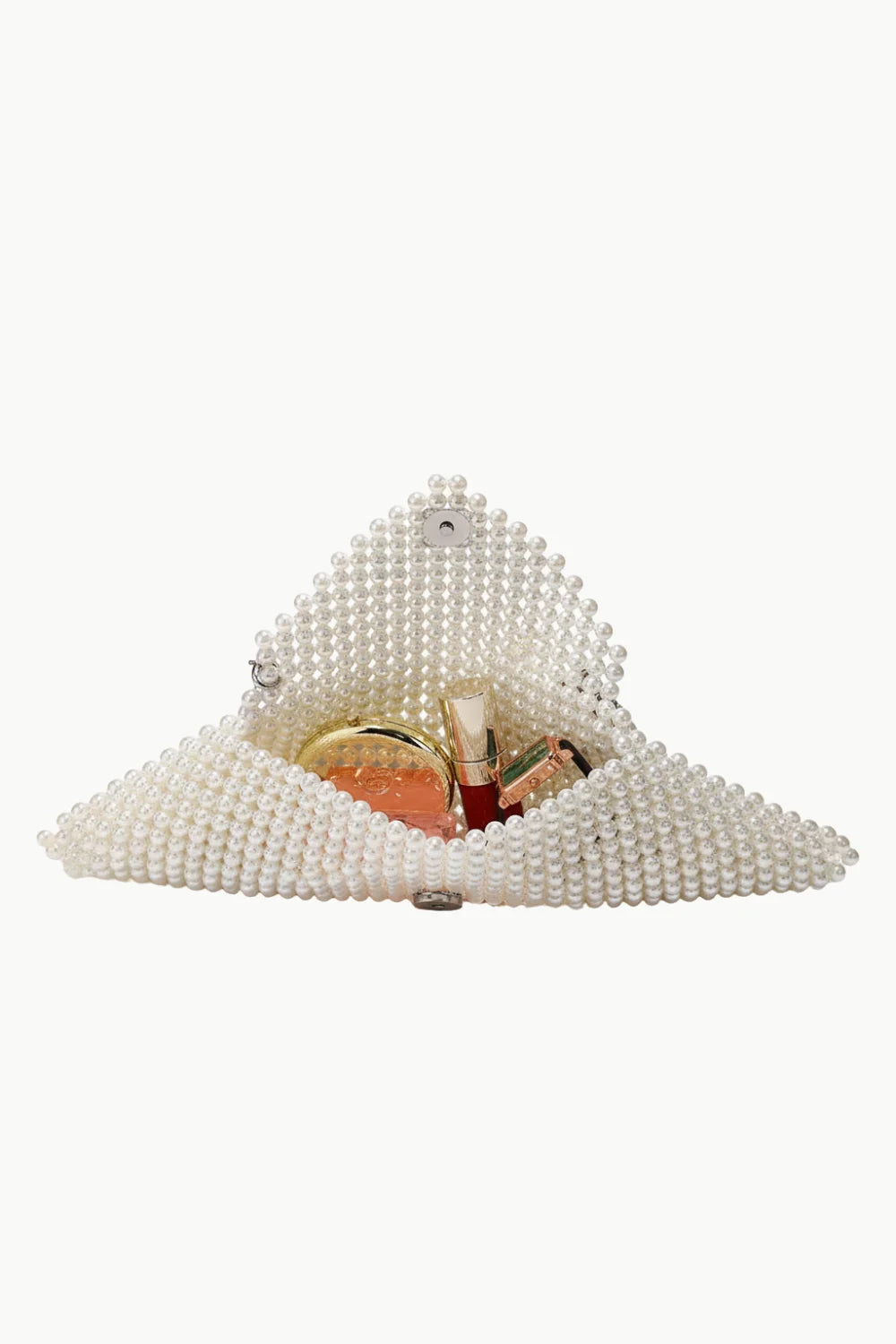 White beaded clutch bag filled with cosmetics, perfect for a Pearl Designer Bag or designer bag accessory