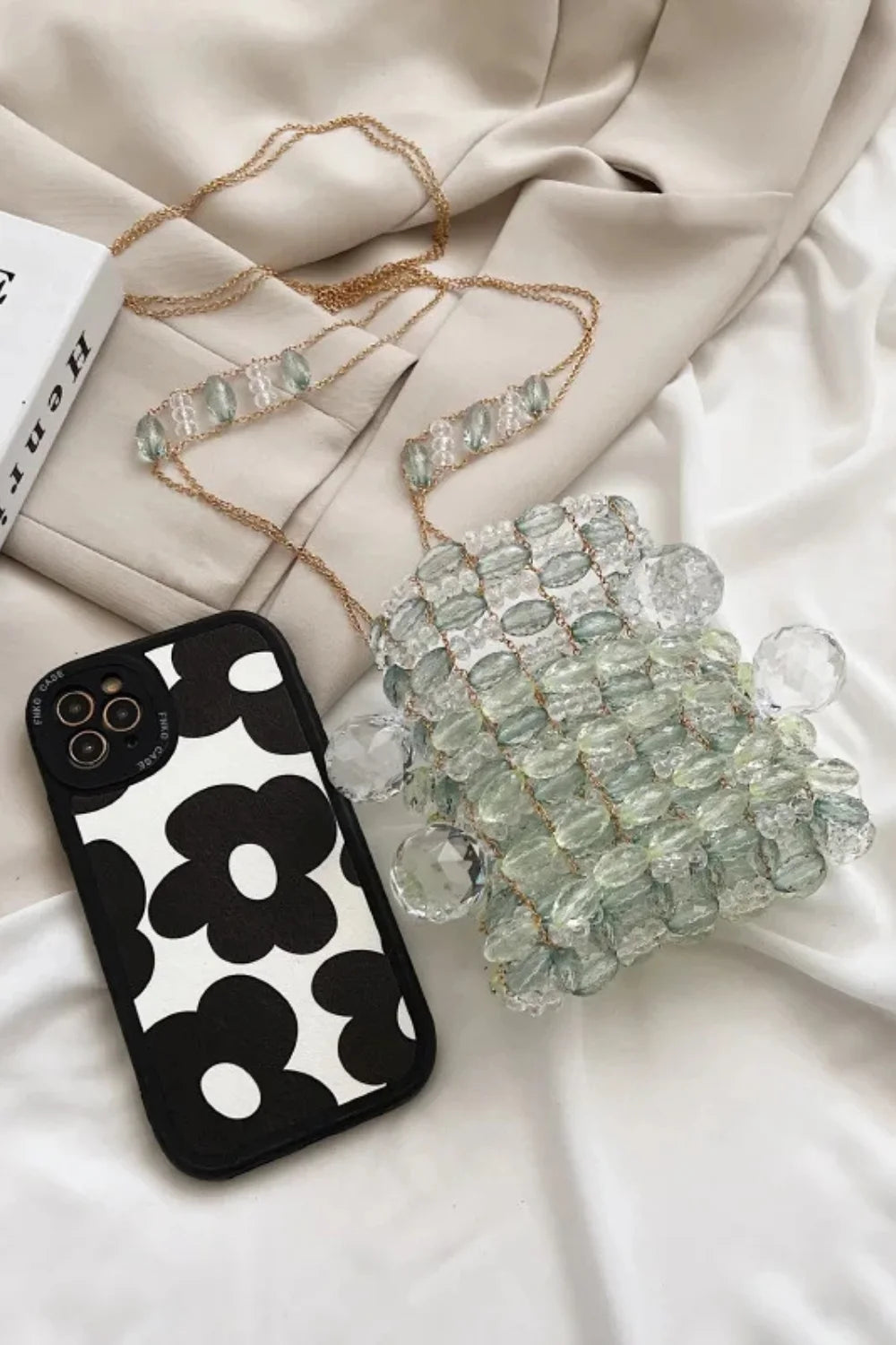 Black and white floral iPhone case on Pink And Orange Beaded Bag, an orange beaded bag