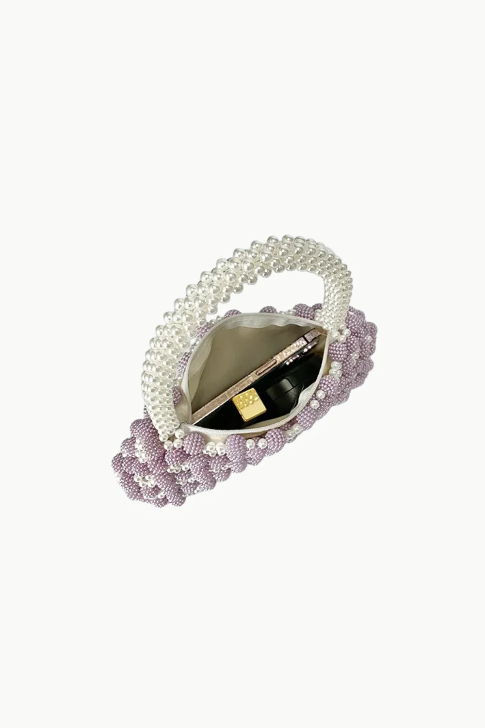Light purple beaded bag with white beaded handle holding pen and small bottle