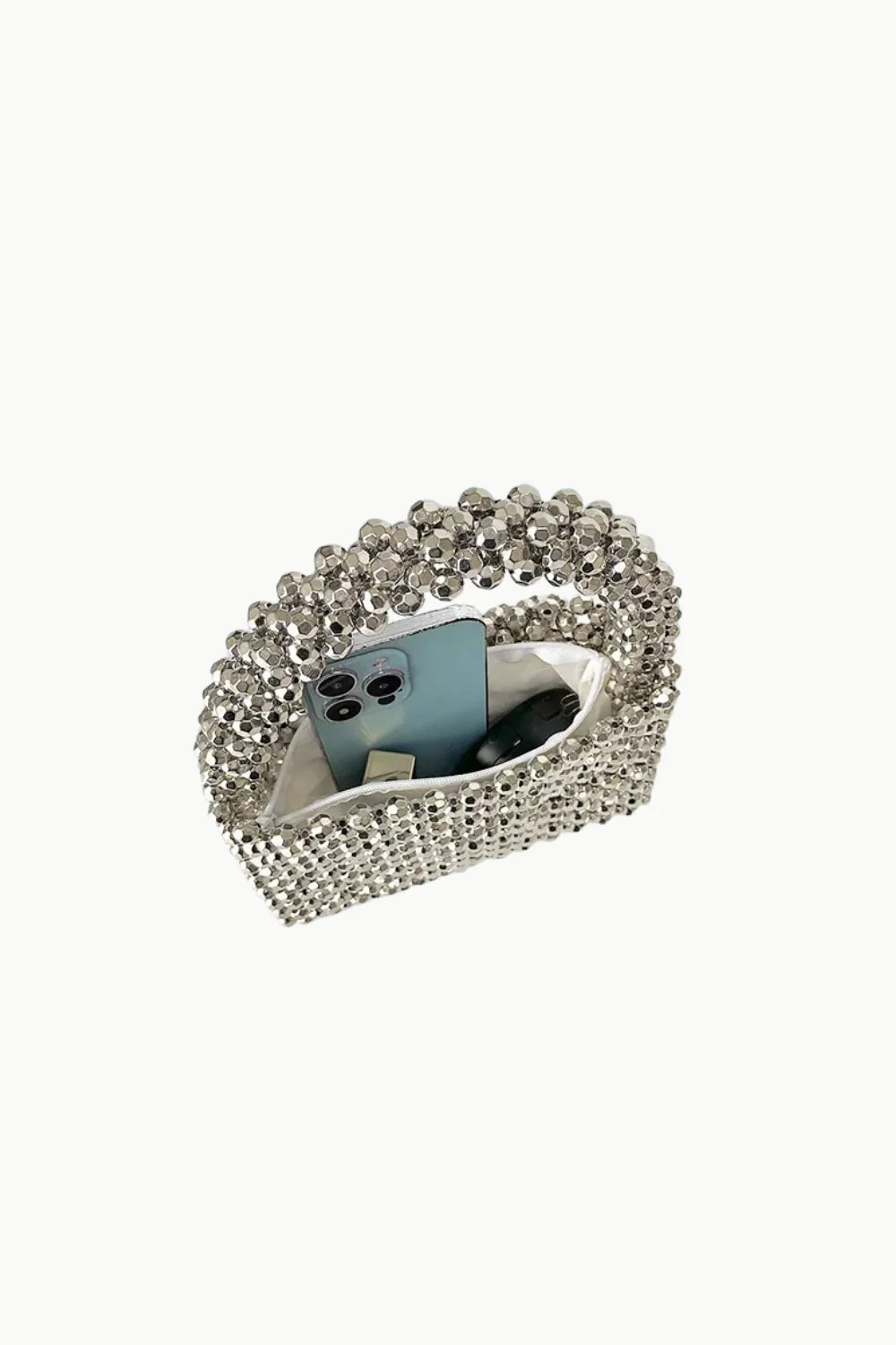 Silver beaded handbag with light blue smartphone and accessories inside