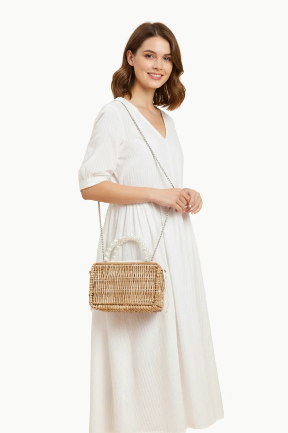 Straw Bag With Pearls showcasing a woven straw bag with pearl beaded handle and shoulder strap