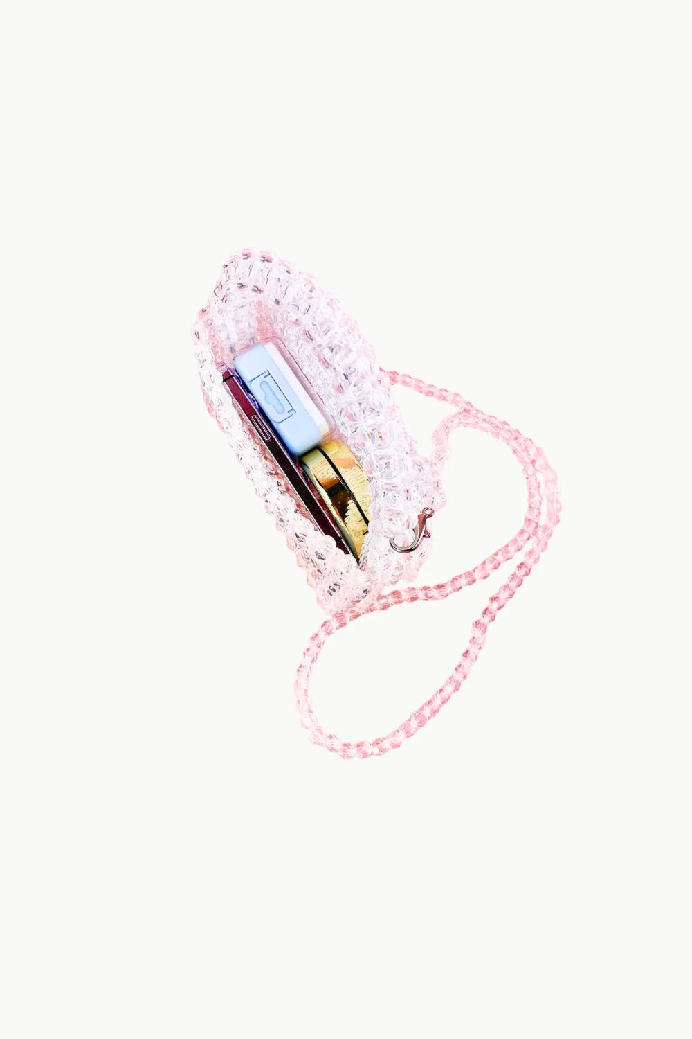 Transparent beaded bag with pink beads, shoulder strap, holding a light blue phone