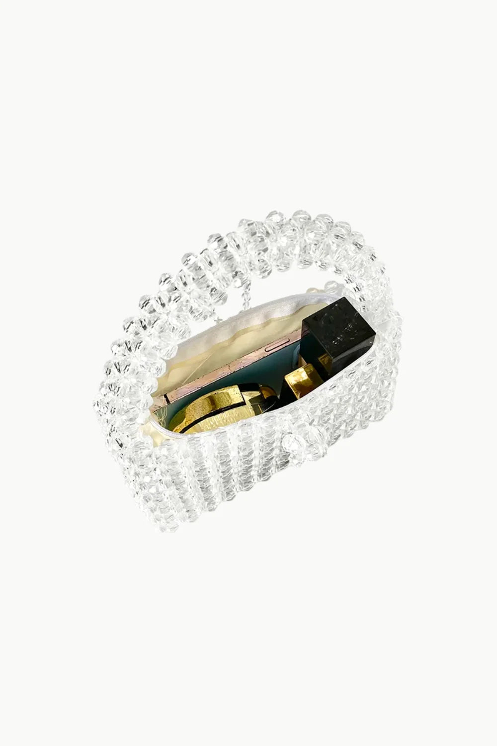 White beaded purse with clear beads and gold and black contents inside