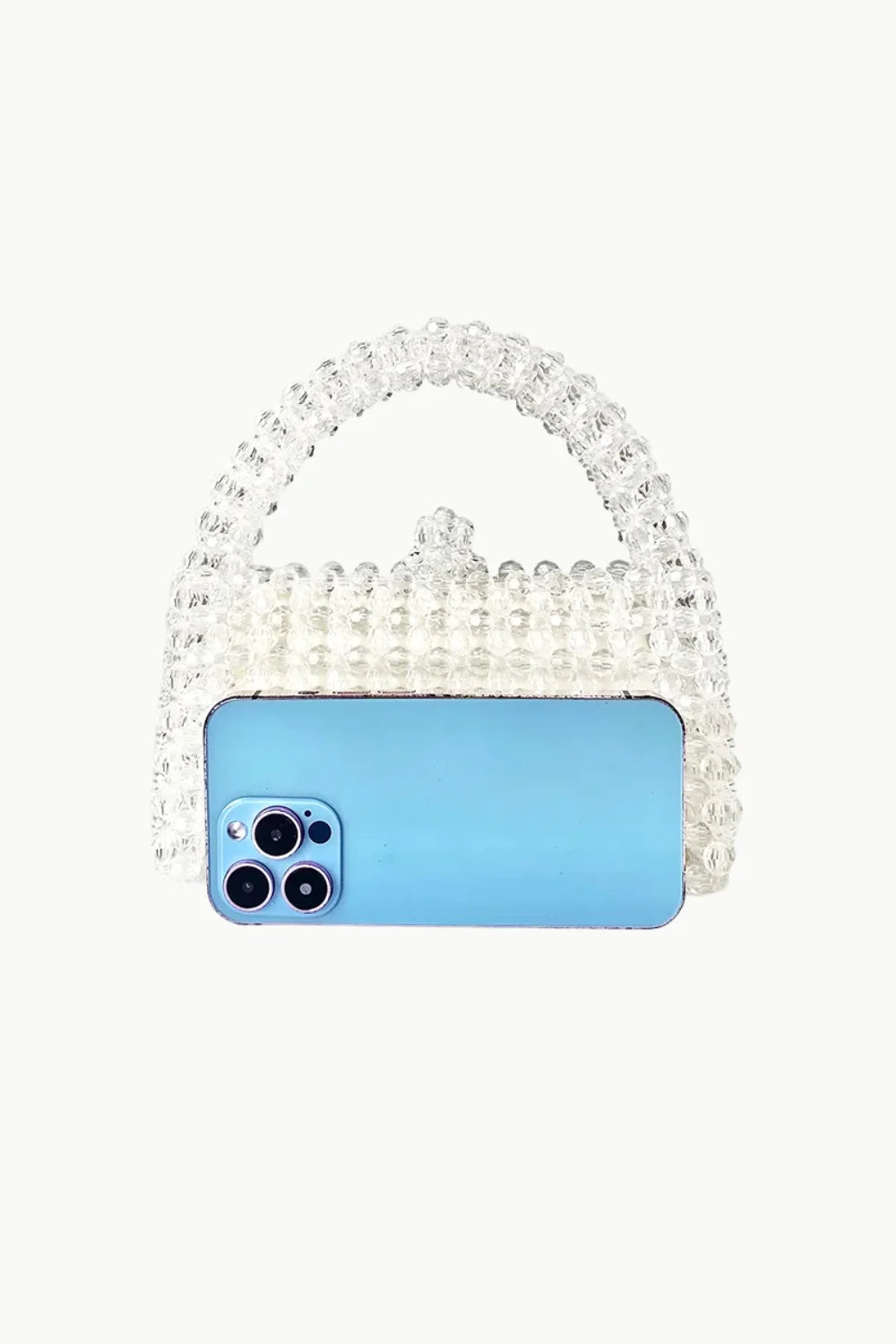 White beaded purse with top handle and light blue smartphone inside, stylish beaded purse