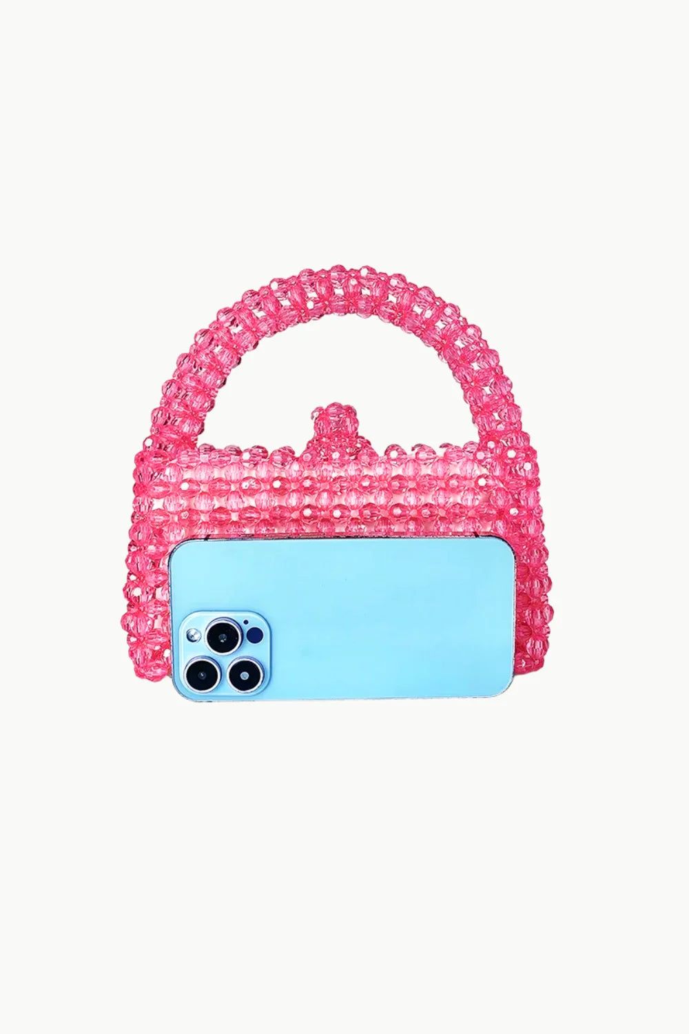 Pink beaded handbag with light blue smartphone in front of white beaded purse