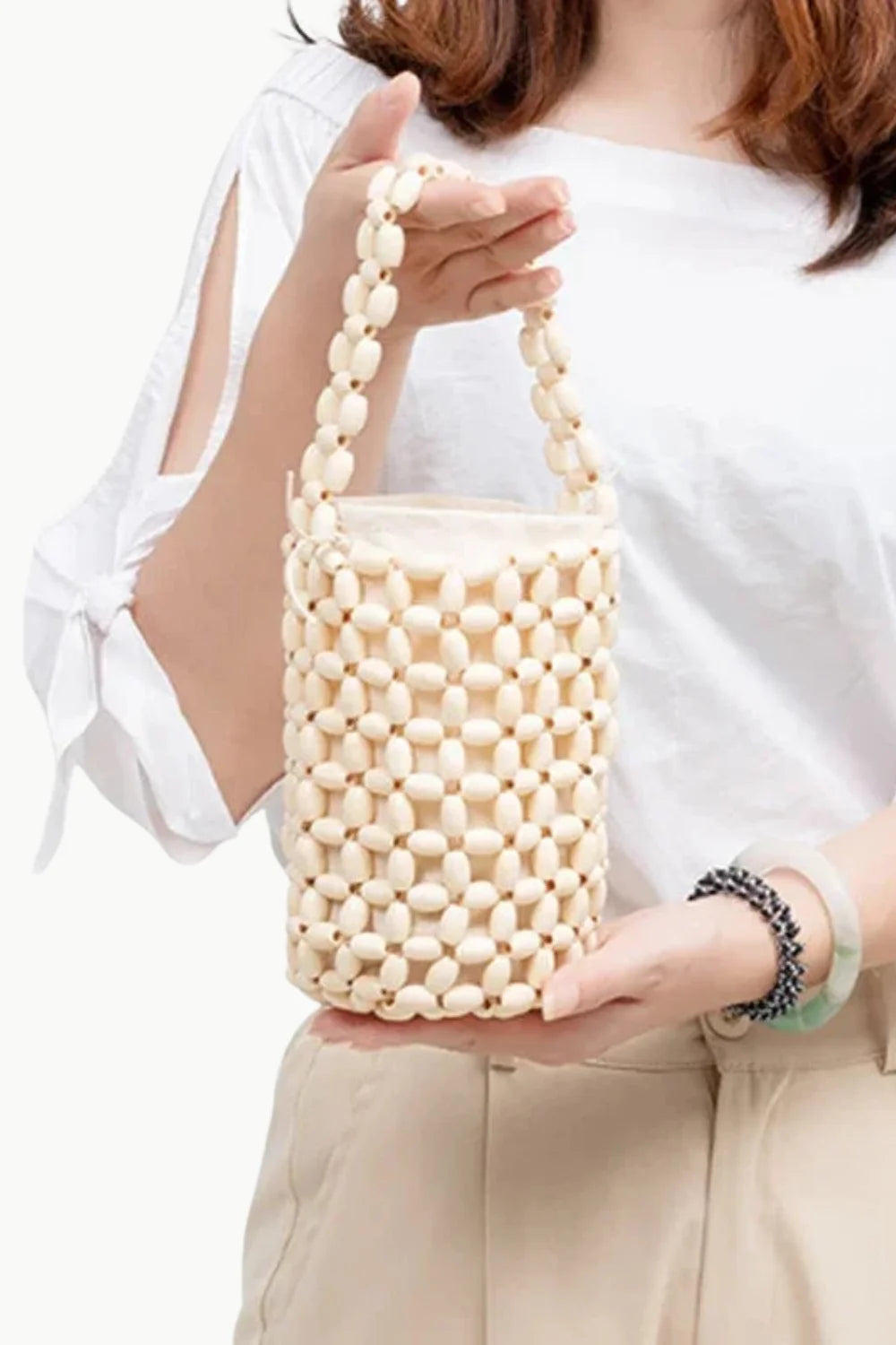 Beige wooden beaded bucket bag with top handle, stylish beaded bucket bag accessory