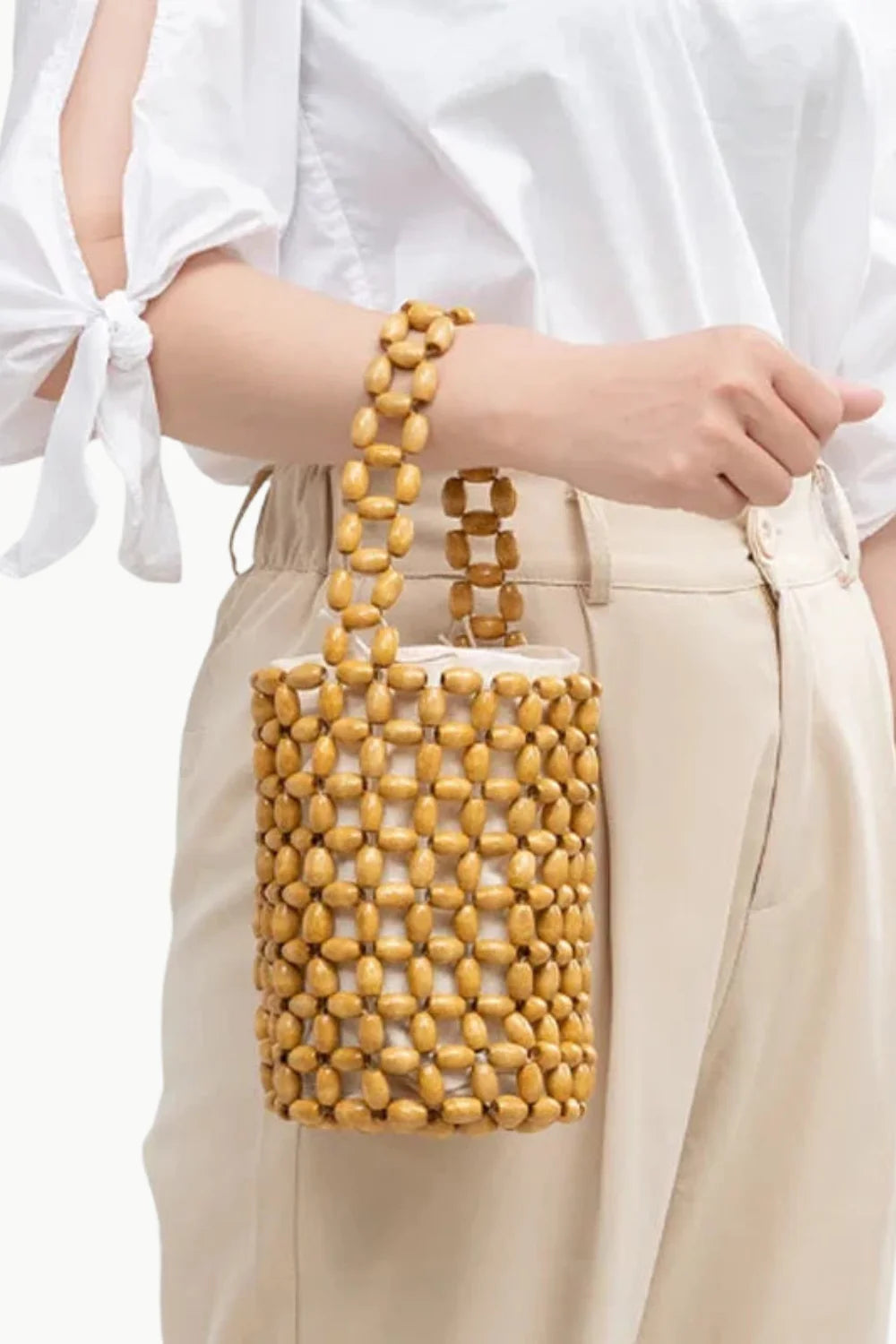 Wood Beaded Bucket Bag with cylindrical design and white fabric lining