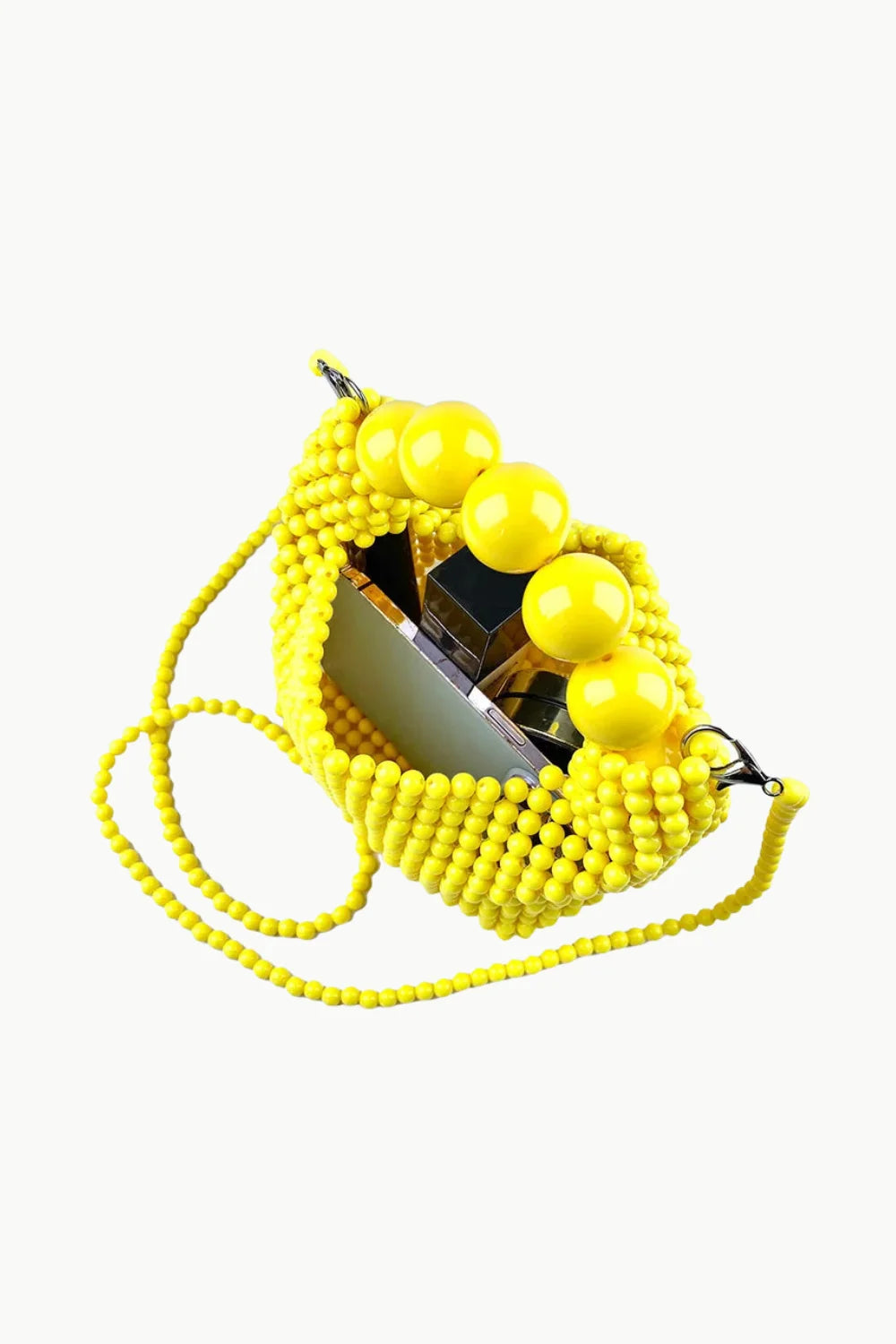 Bright yellow beaded handbag with spherical handles and shoulder strap for stylish use
