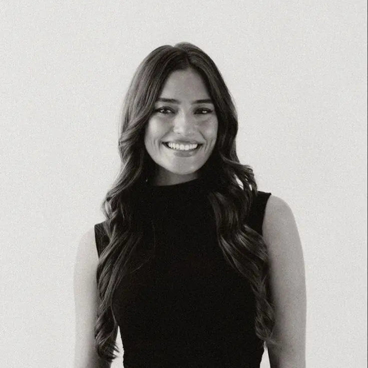 Woman in sleeveless top, clean studio portrait for Beaded Bag lifestyle and elegant accessory branding.