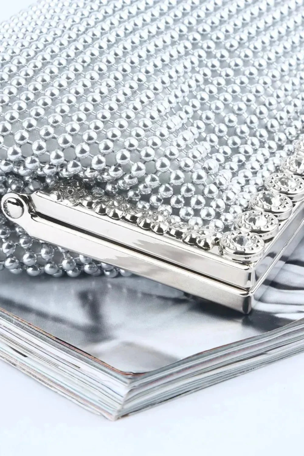 Silver beaded clutch bag adorned with rhinestones for elegant evening wear