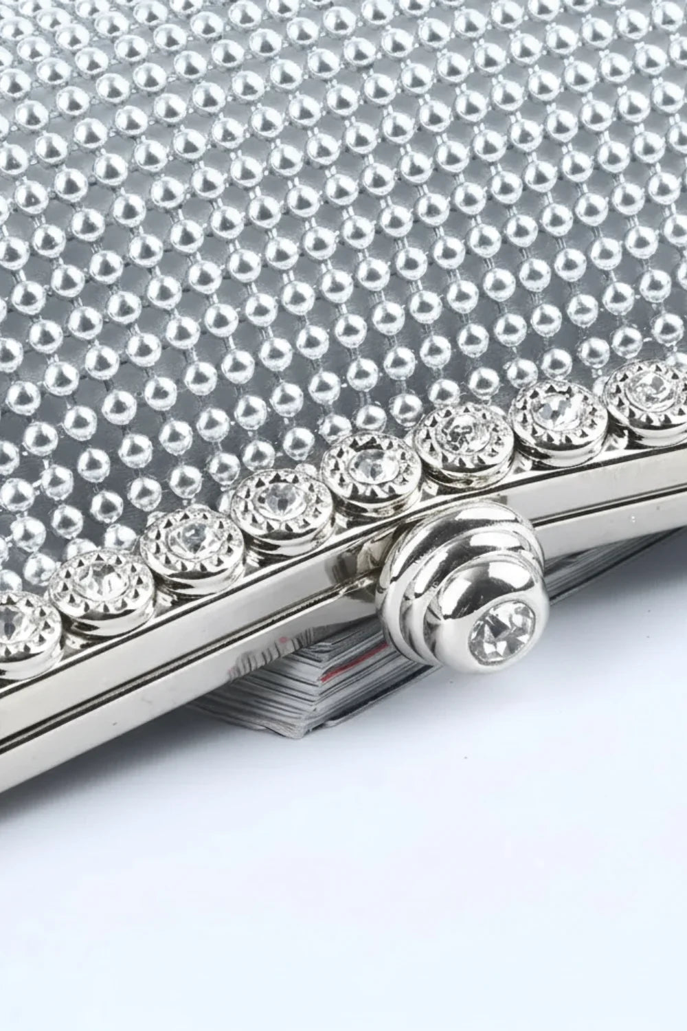 Silver beaded clutch bag with jeweled clasp and decorative crystals for elegant style