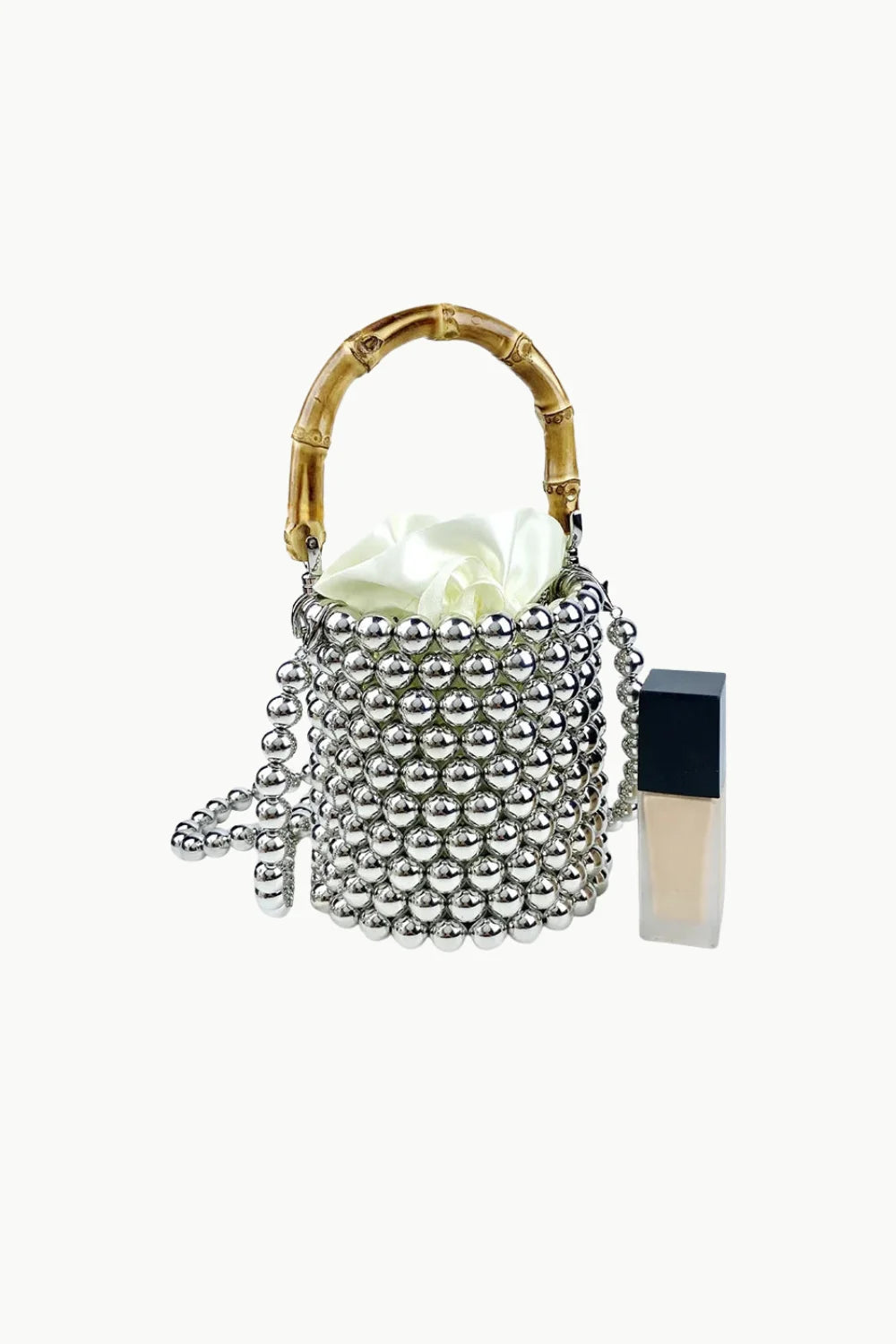 Silver beaded crossbody bucket bag with bamboo handle and white fabric lining