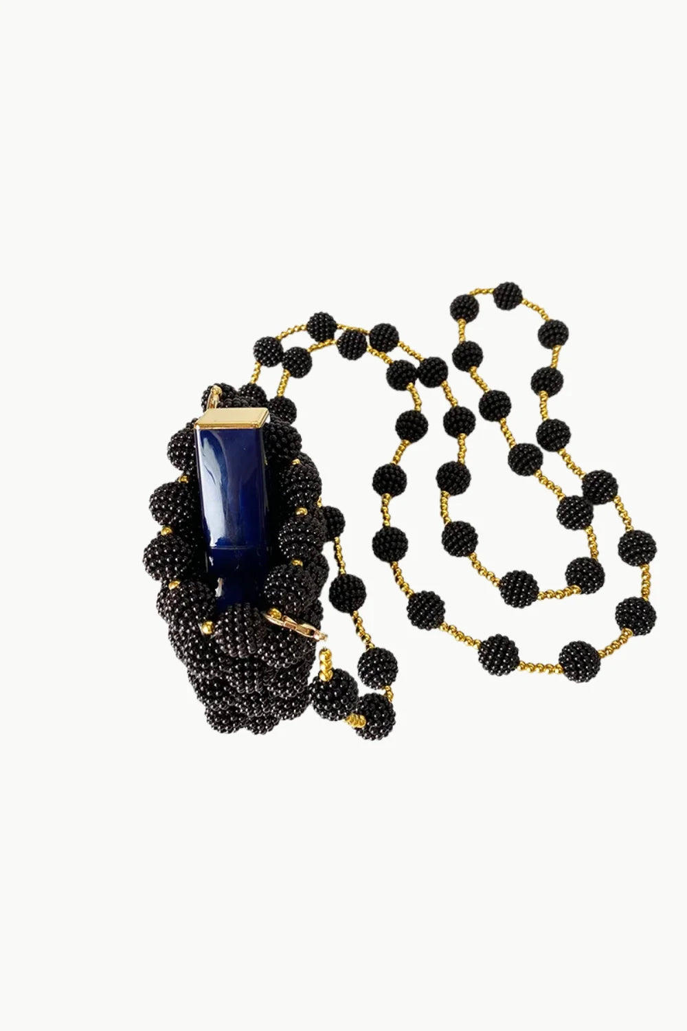 Beaded Knoted Mini Bag featuring a long black beaded necklace with blue and gold pendant