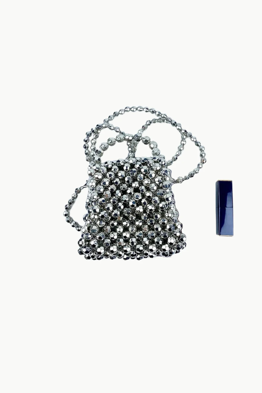Silver beaded mini hand bag with long strap and dark blue lipstick accessory