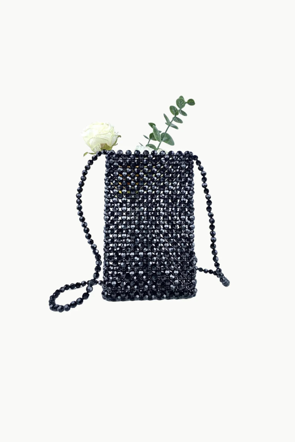 Beaded mini shoulder bag with white flower and green foliage decorative accents