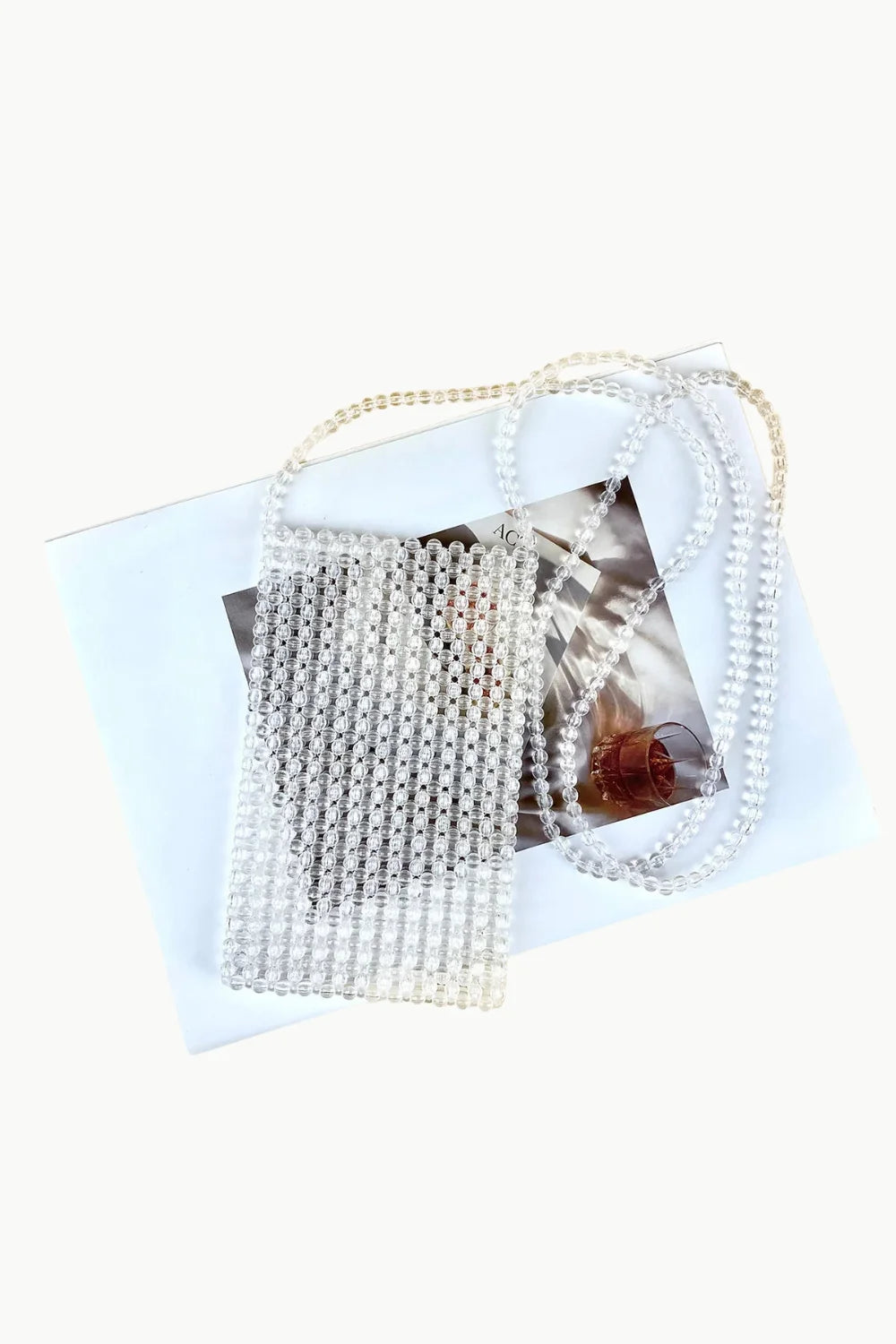 Beaded phone strap crossbody bag with clear rectangular design and long strap