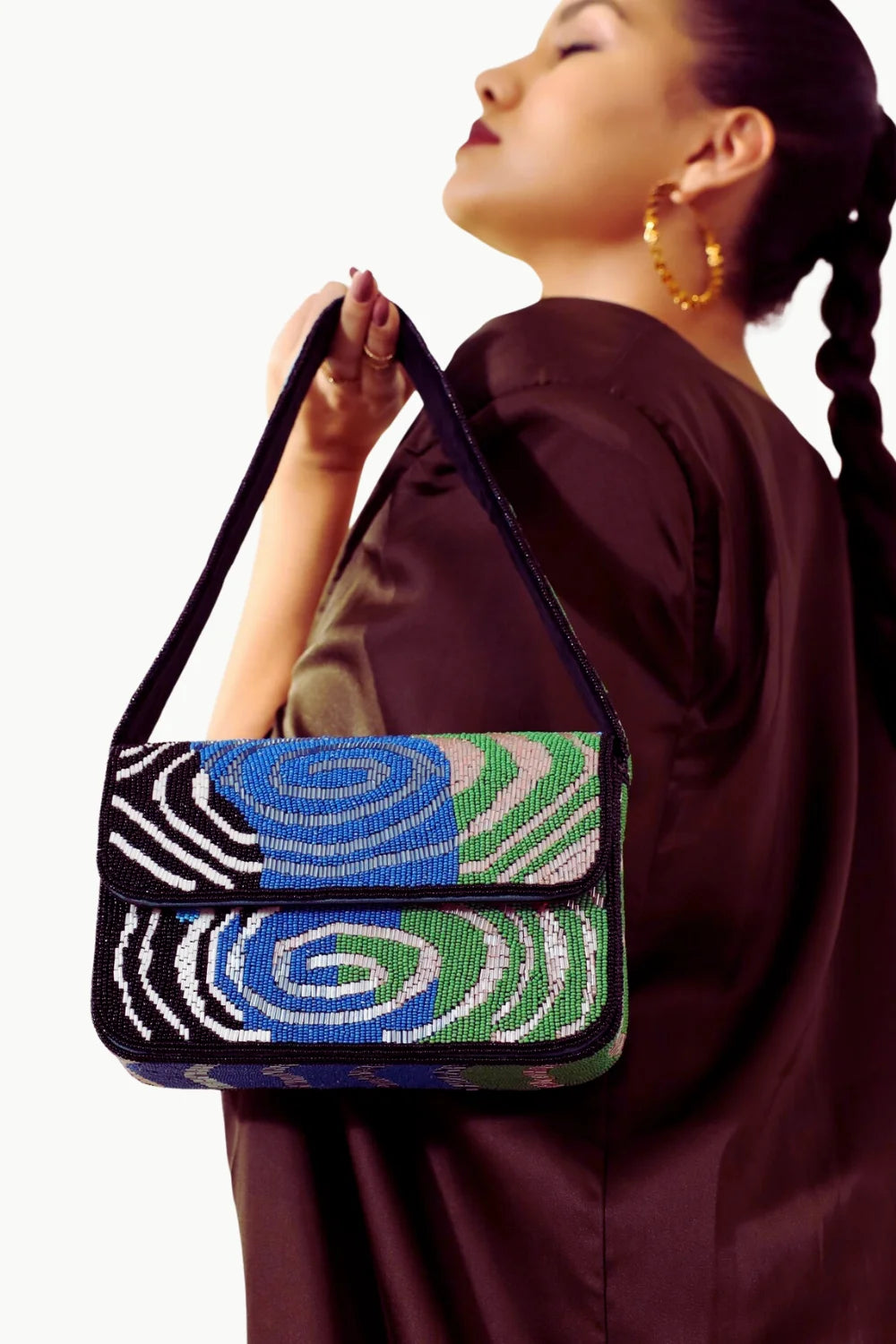 Black shoulder bag with multicolored beaded purse pattern and spiral striped design