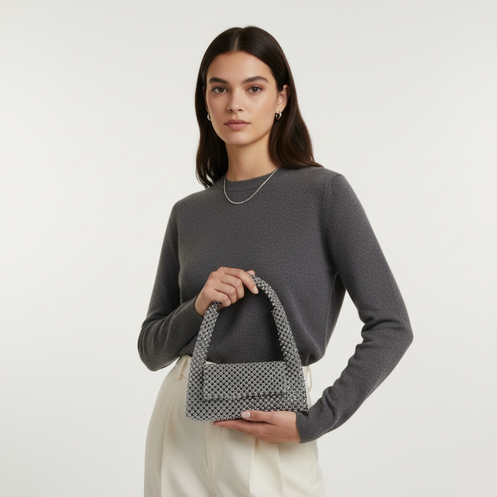 Silver-black beaded purse on model. Image