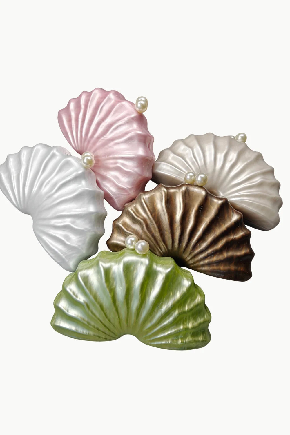 Beaded Shell Bag featuring five seashell-shaped handbags with pearl accents for elegant style