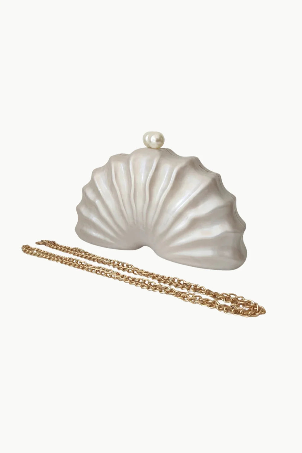 Beaded Shell Bag featuring a white shell-shaped clutch with pearl clasp and gold chain