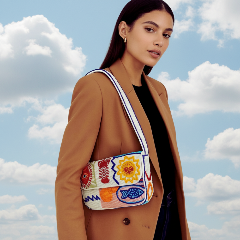 Model wearing a colorful beaded shoulder bag with geometric beadwork.