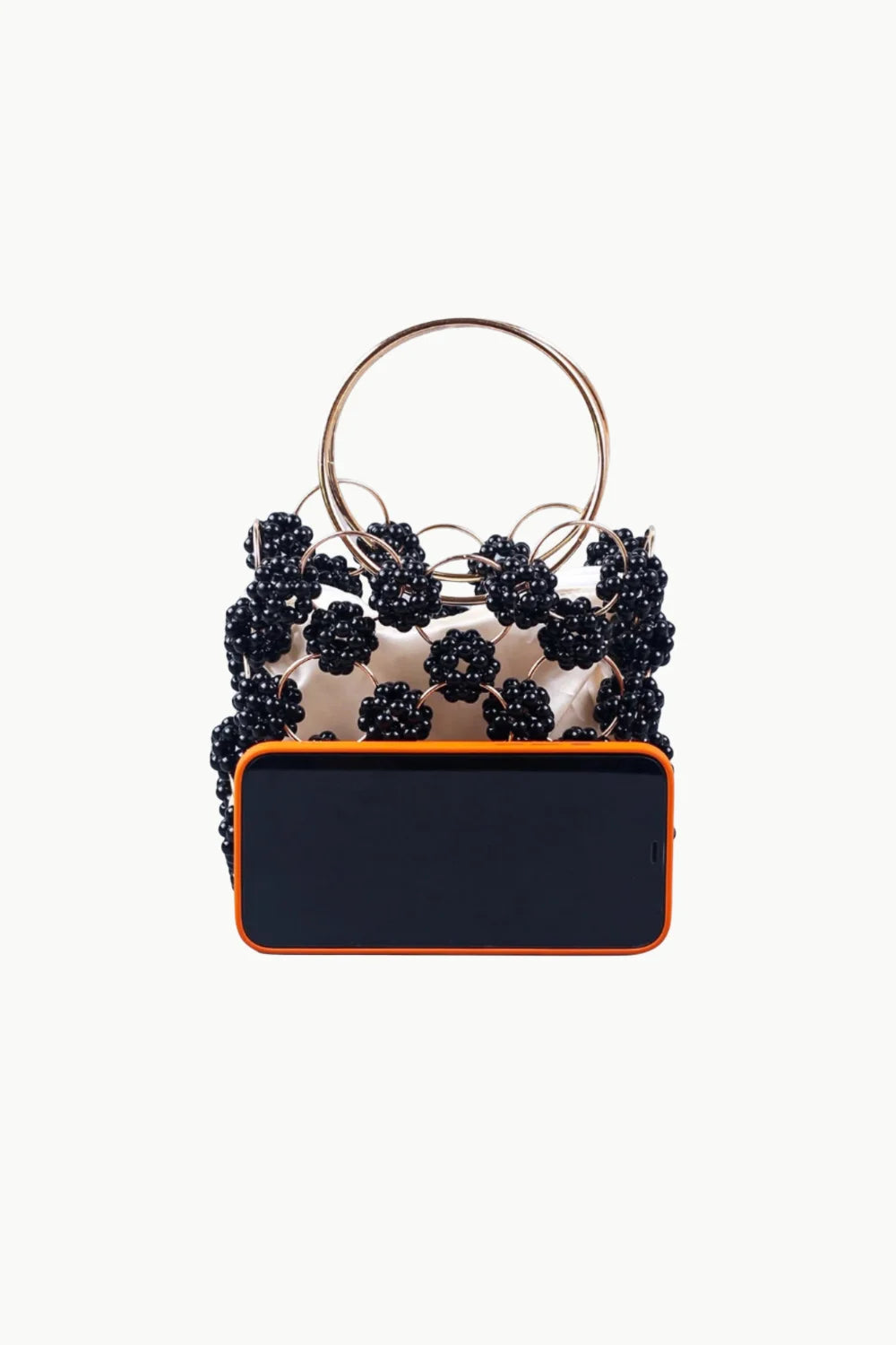 Black beaded bucket bag with gold ring handle and orange-rimmed phone inside