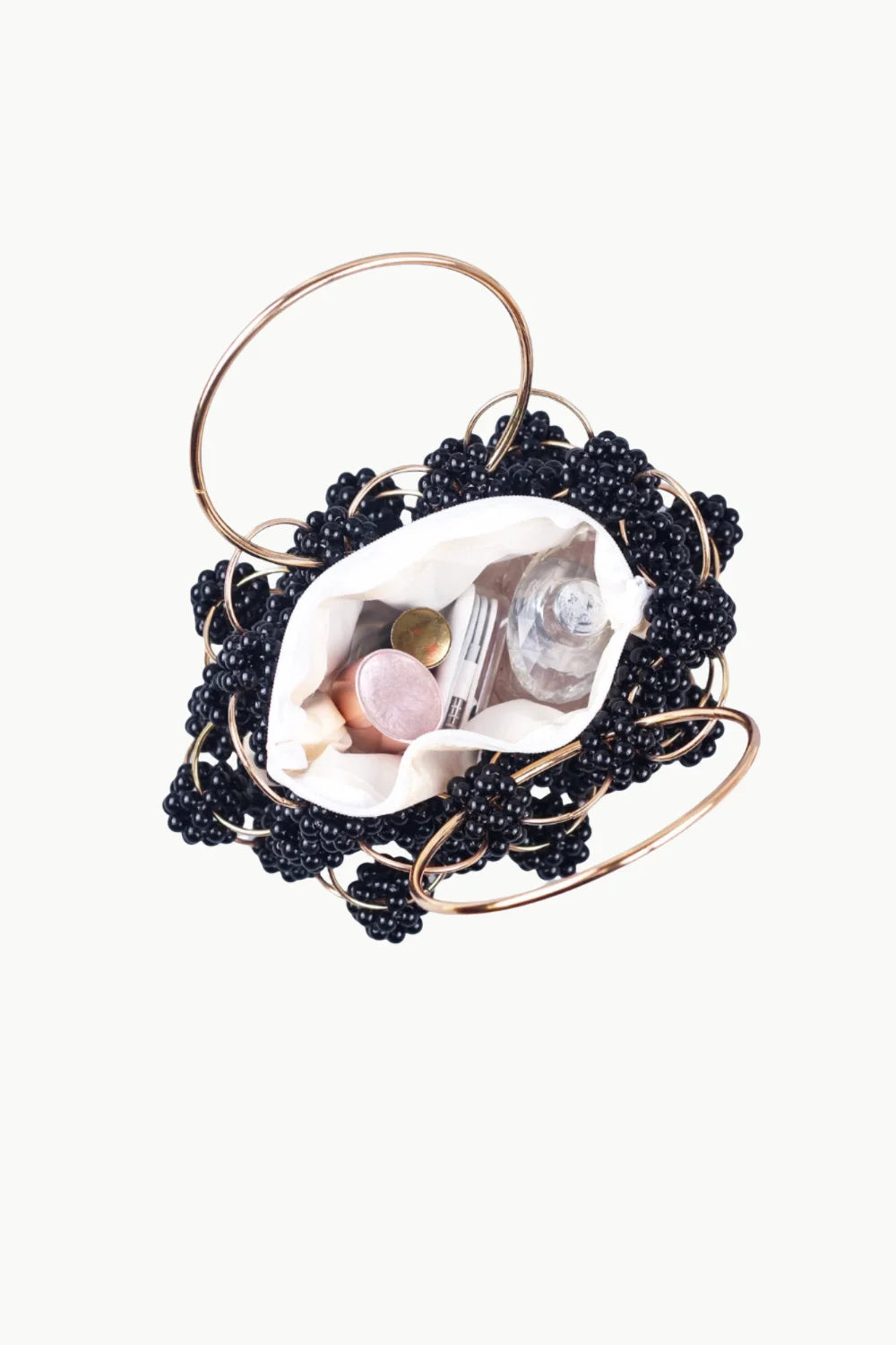 Black beaded bucket bag with gold-tone handles and white fabric pouch insert