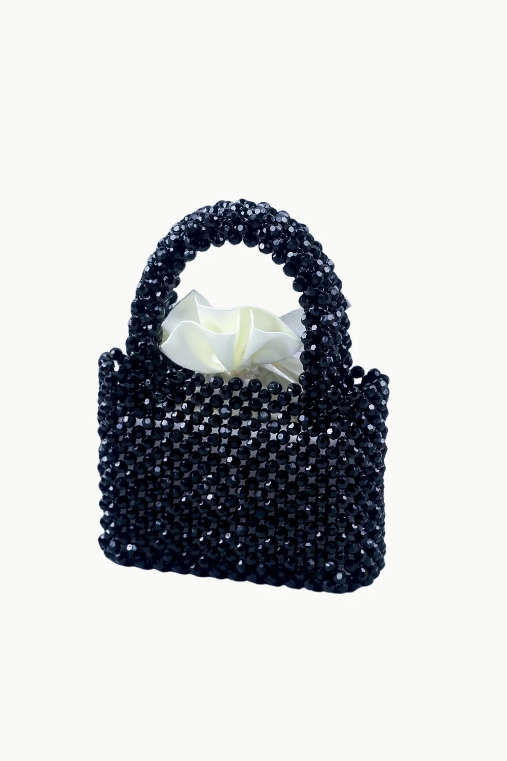 Black beaded handbag with white ruffled interior pouch showcasing elegant design