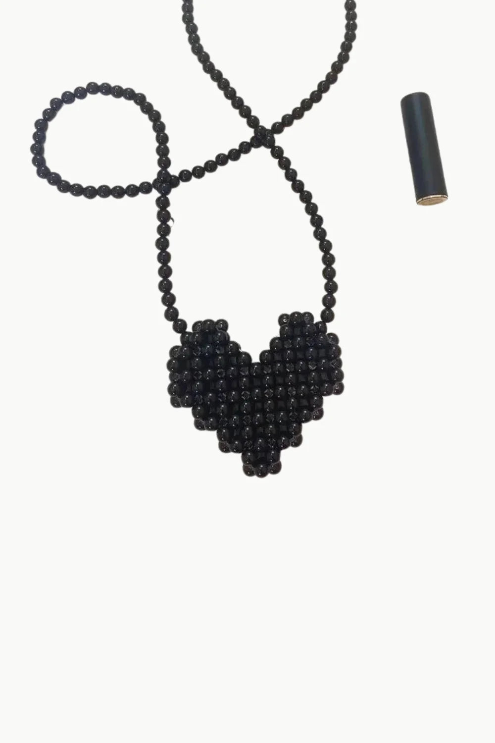 Black mini beaded bag featuring a black beaded necklace with heart-shaped pendant