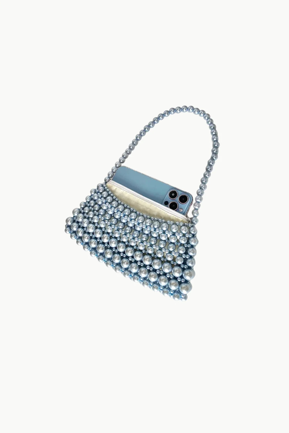 Pearlescent blue beaded evening bag with phone tucked inside, stylish beaded evening bag