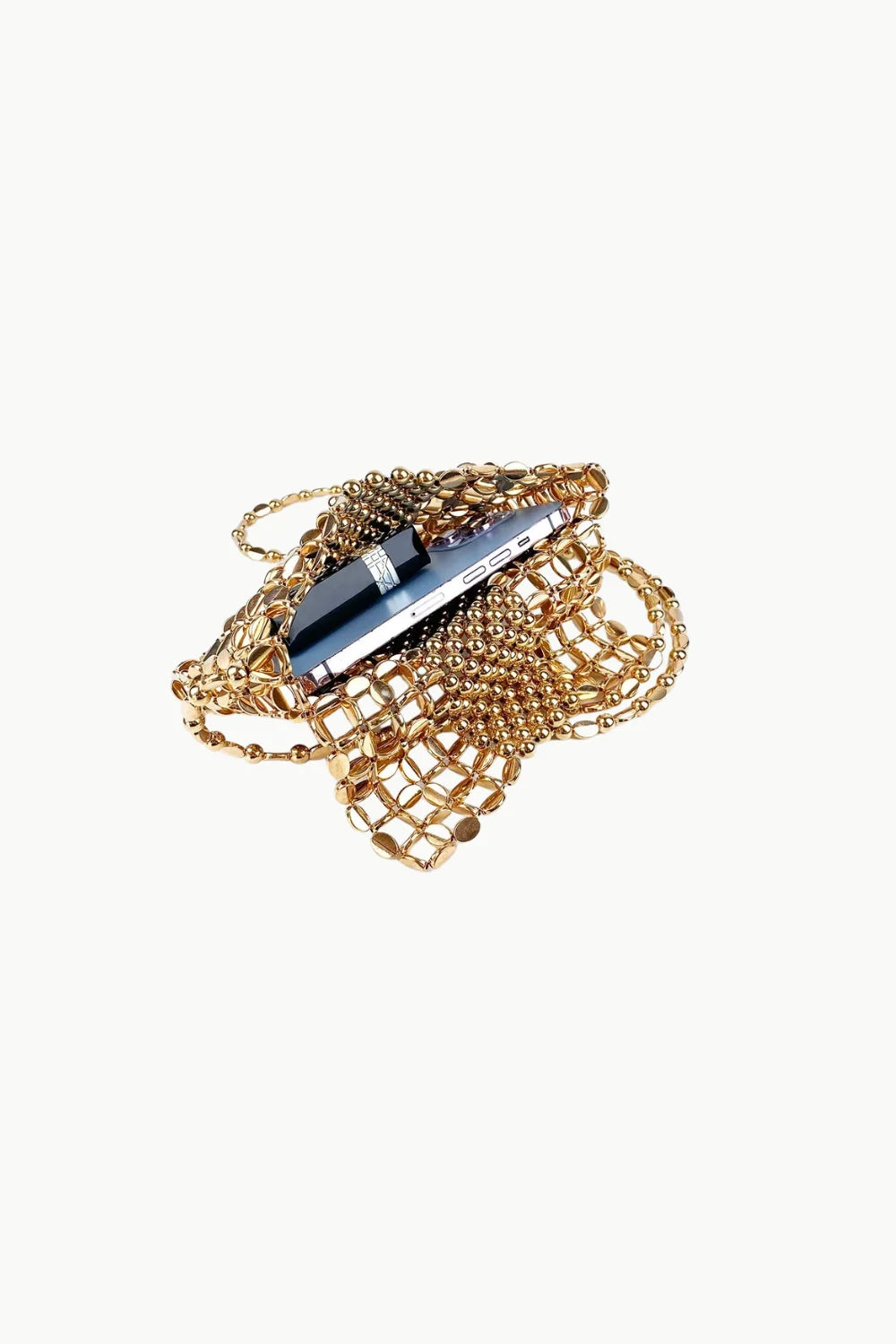 Tangled gold-colored jewelry with a black and silver pen on a bronze beaded bag