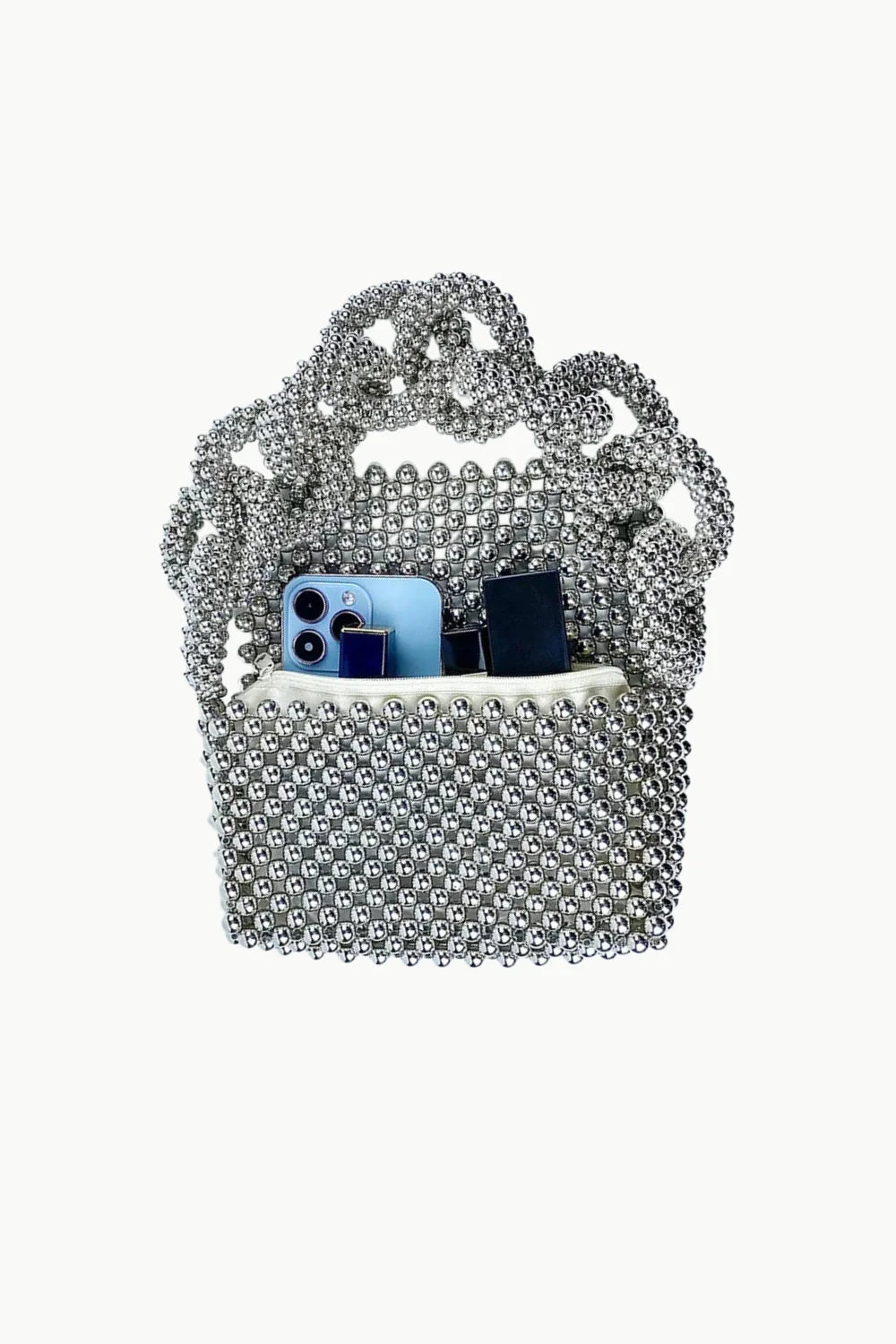 Silver chain strap beaded handbag with phone and small black item inside