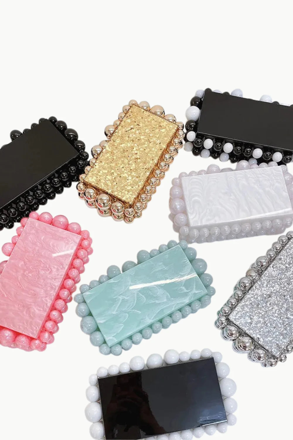 Colorful collection of custom beaded clutch bags with beaded frames and varied textures