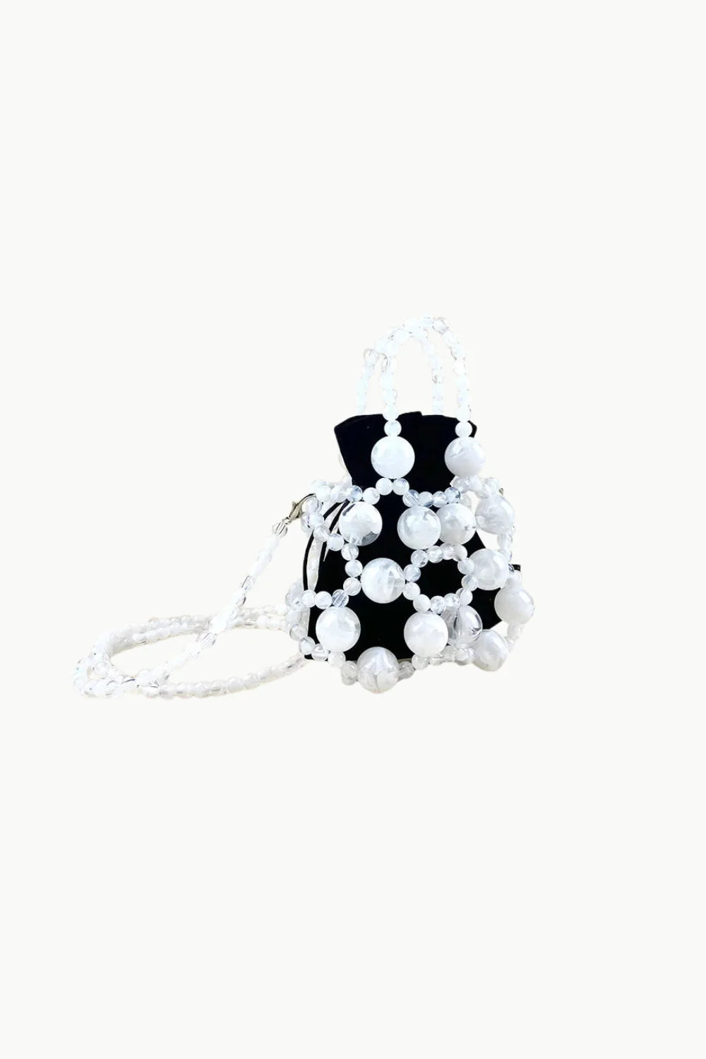 Black drawstring pouch bag with white beaded overlay and matching gold beaded shoulder strap for stylish beaded bucket look