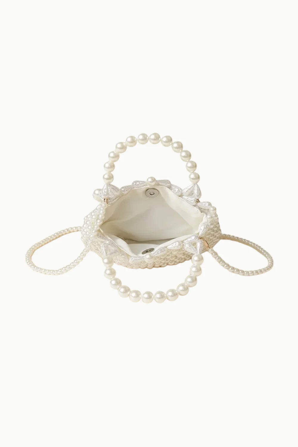 White beaded Magnolia Pearl Bag with pearl handles and drawstring closure for elegant style