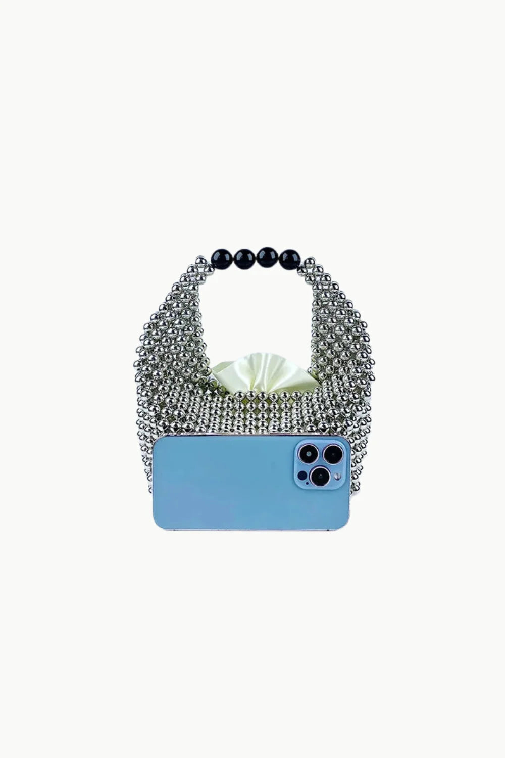 Silver metallic beaded bag with black spherical handles and a light blue smartphone in front