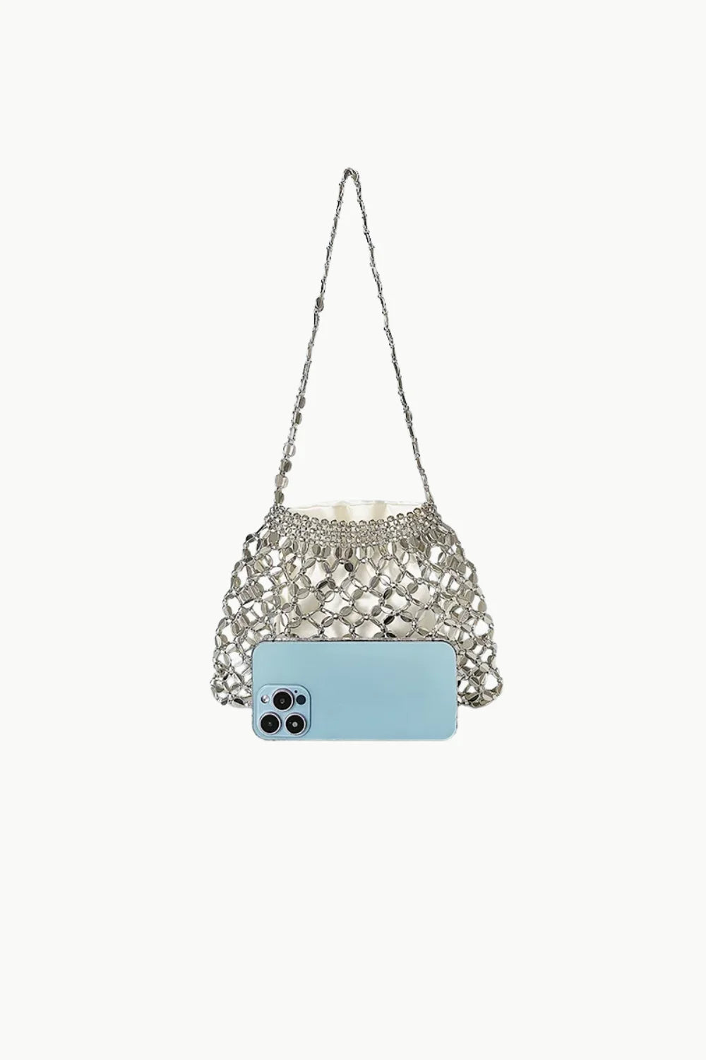 Silver-toned metallic beaded shoulder bag with embellishments and light blue smartphone for scale