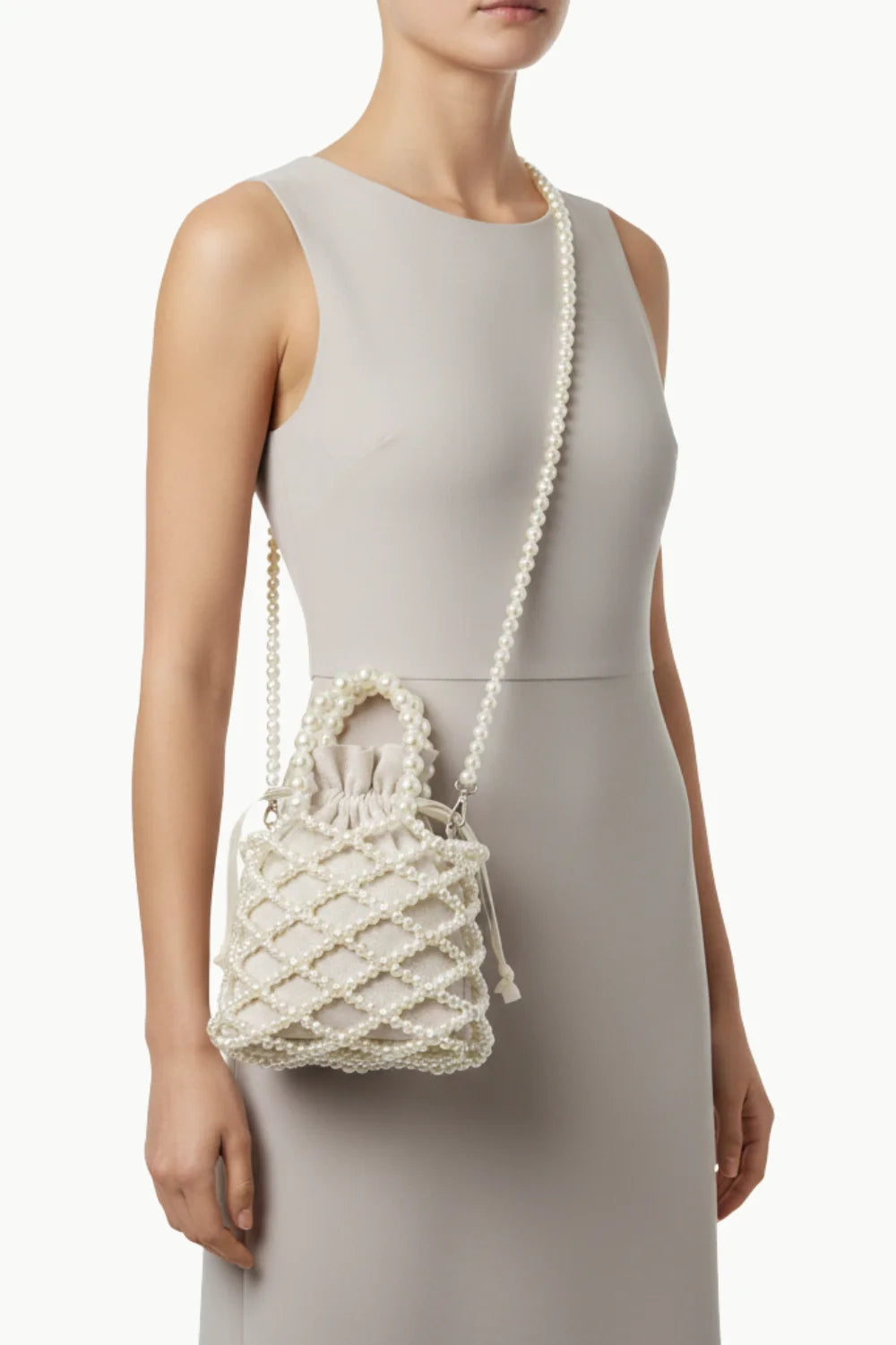 White pearl beaded bucket bag with top handle and long shoulder strap