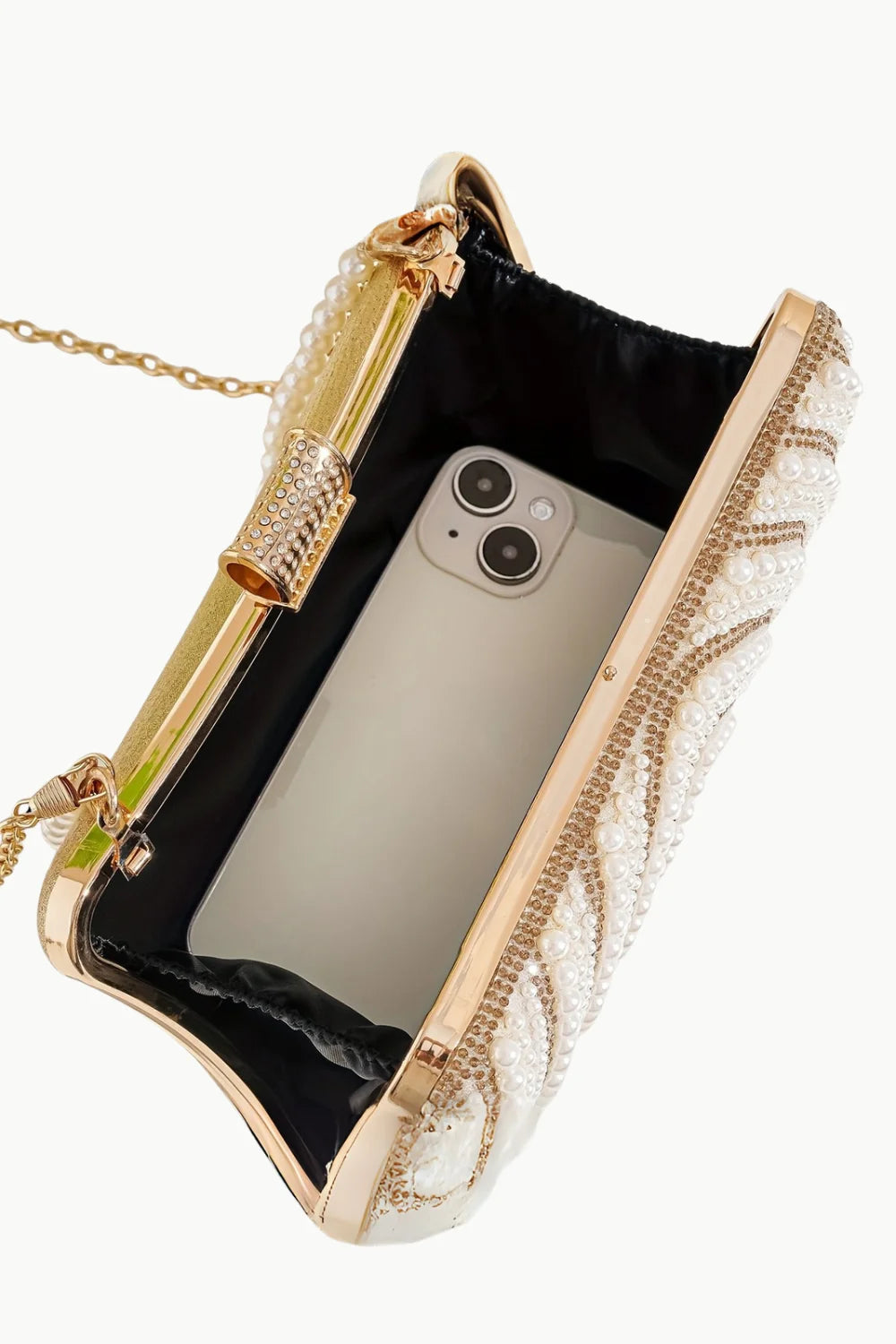 Pearl Beaded Clutch with gold accents, chain strap, and smartphone inside