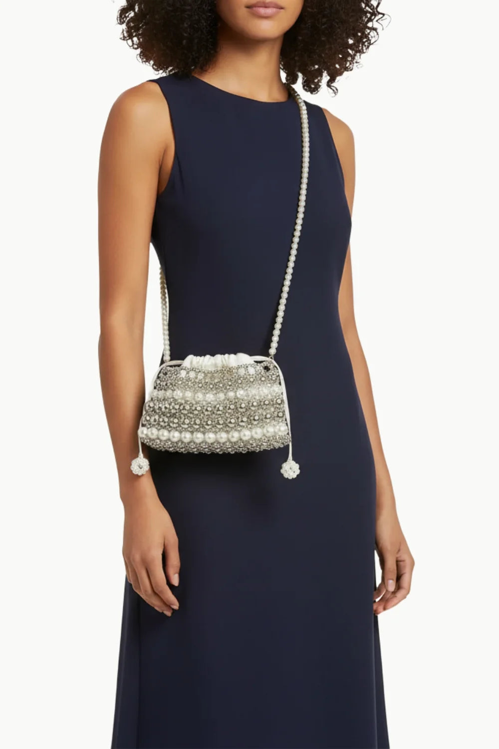 Pearl clutch bag for wedding featuring a woman’s pearl-embellished drawstring shoulder bag
