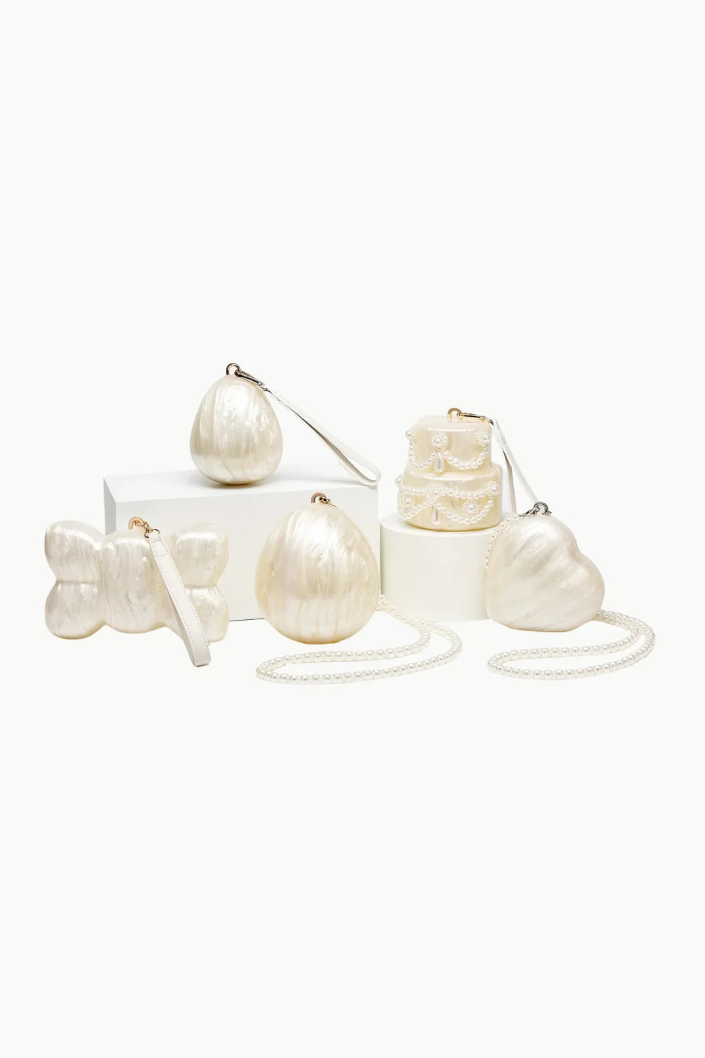 Pearl mini bag with five iridescent pearl-white ornaments in various shapes and silver hangers