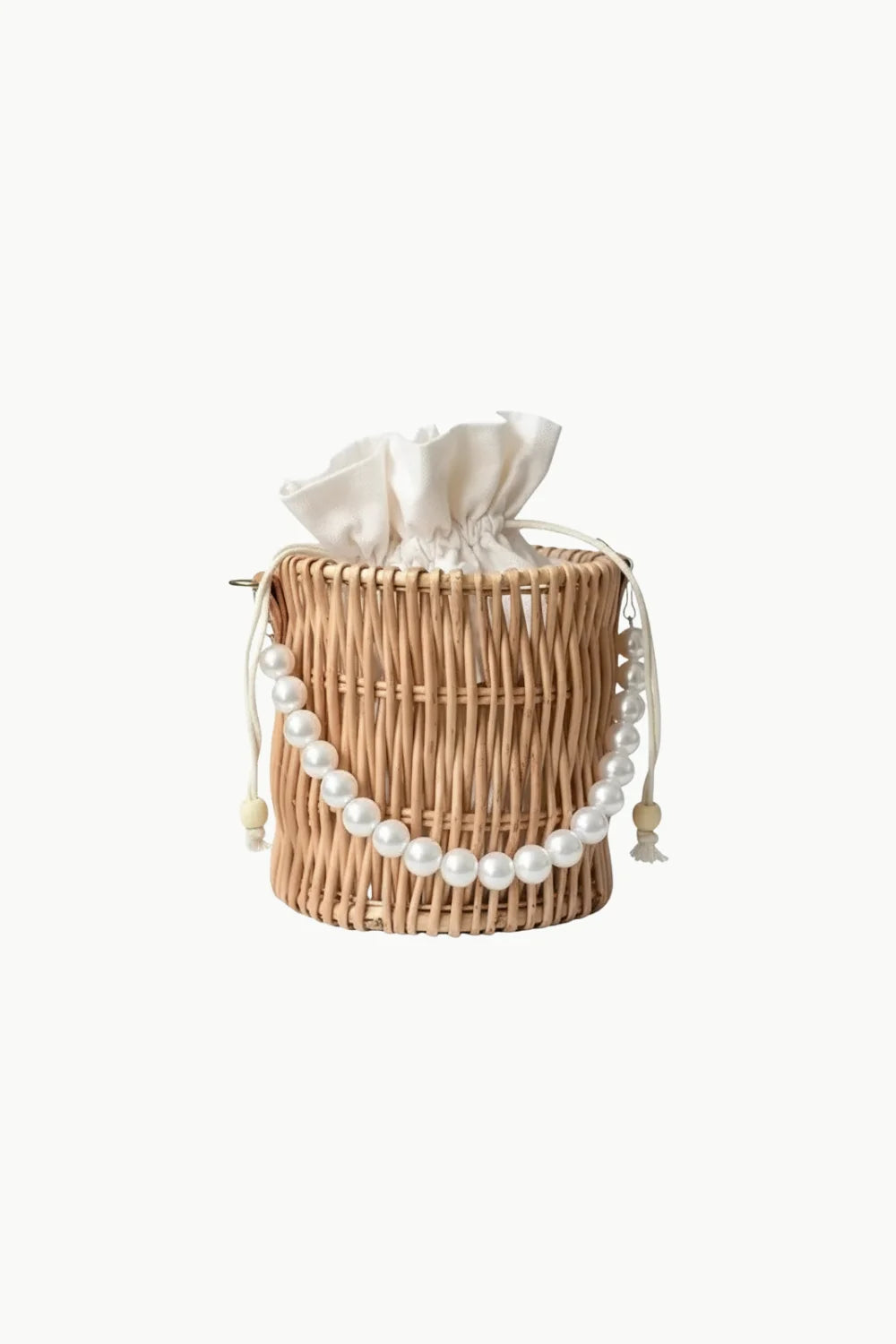 Pearl Straw Bag featuring woven wicker design, white ruffled drawstring top, and pearl beaded strap